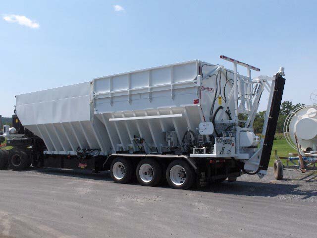 Left-rear view of custom batching machine containing 2 sealed bins. This view has the control pannel and chute.
