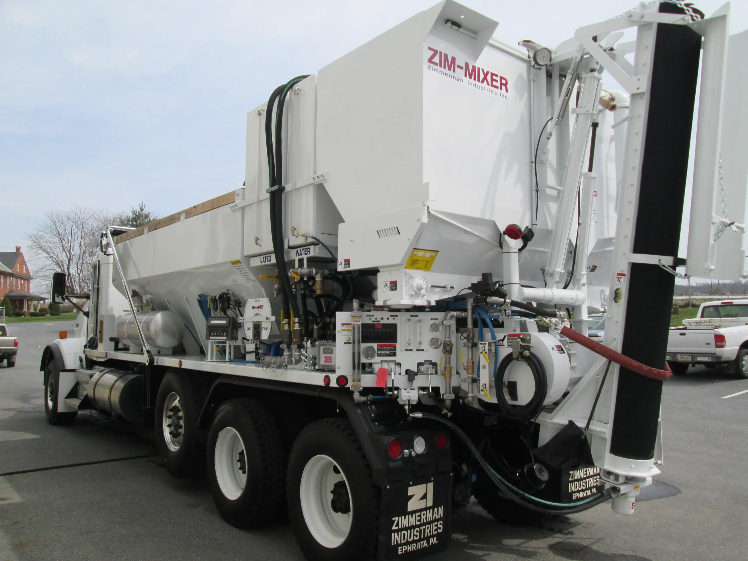 A concrete company driving a volumetric concrete mixer to job site for a latex based concrete pour. Volumetric concrete mixer allows for on-site loading and fresh concrete mixing on the job site.
